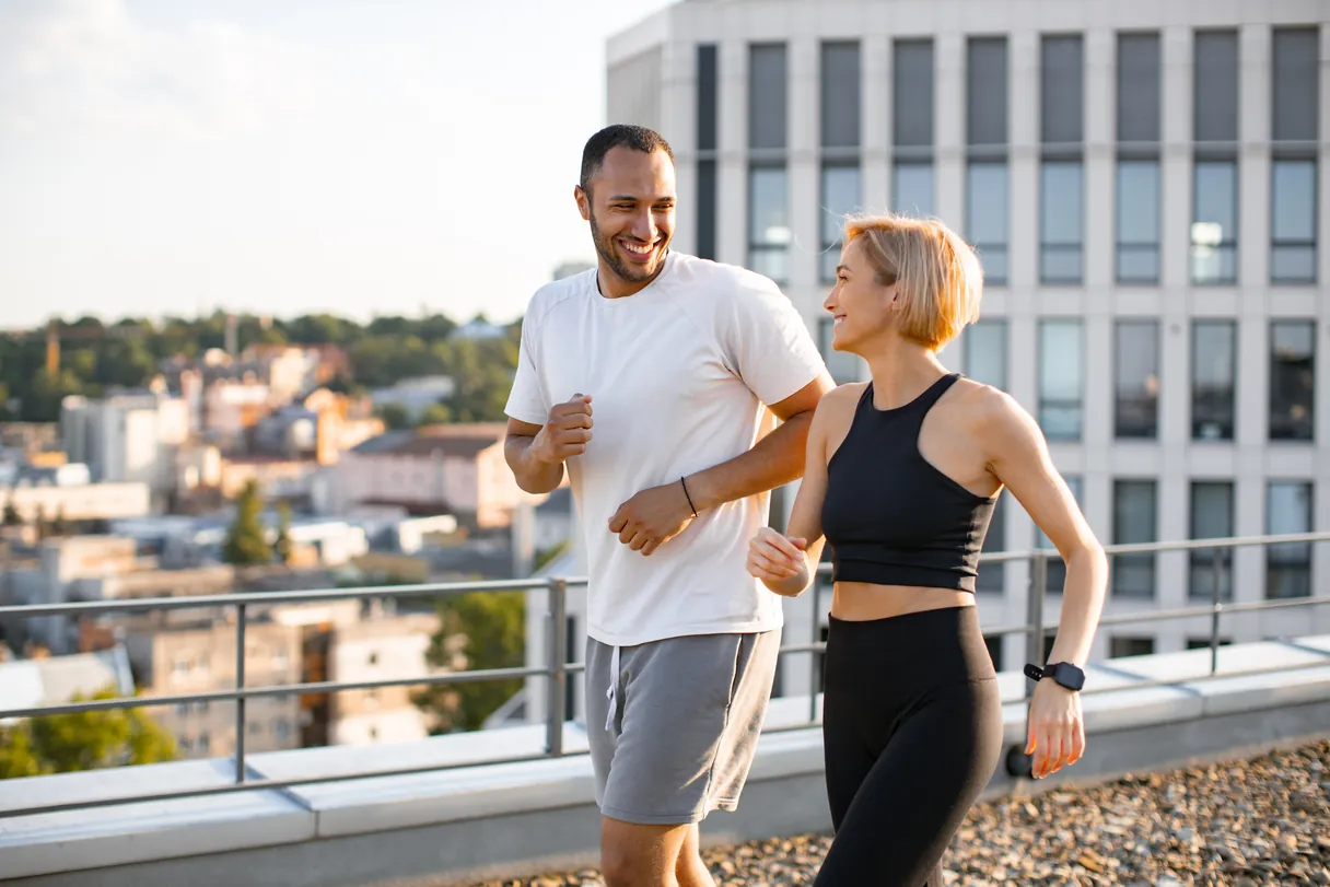 Couple jogging outdoors, feeling healthy and energized